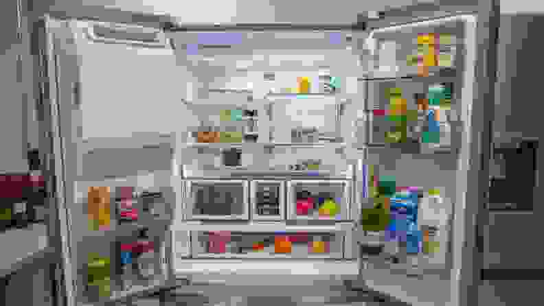 A close-up of the Whirlpool fridge's interior, showcasing its shelves and bins stocked with food and drinks.