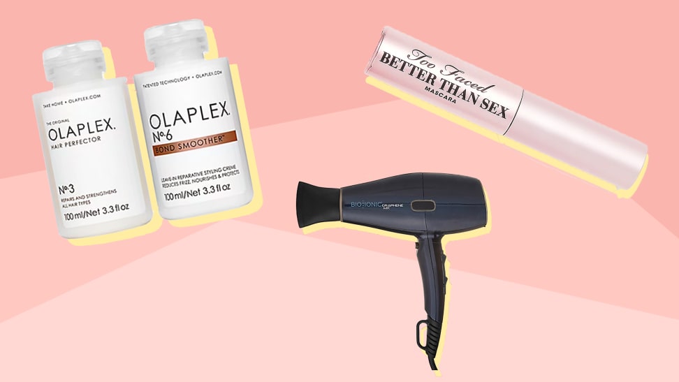 Olaplex, hair dryer, and mascara on a pink bakcground