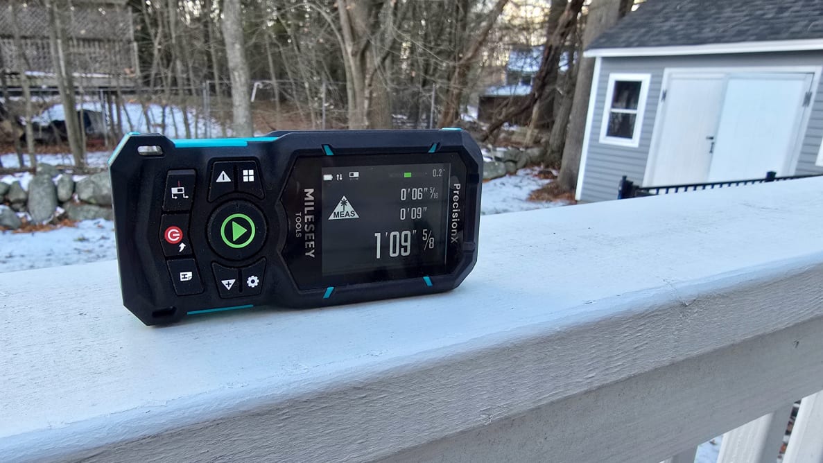 A laser level sits on a railing outside