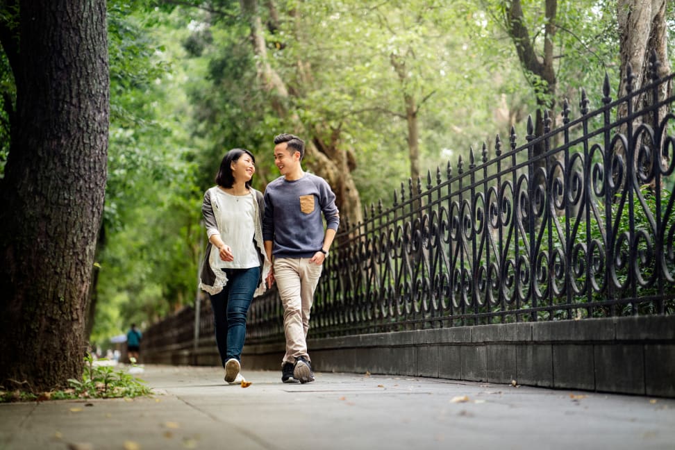 man and woman walk on pavement