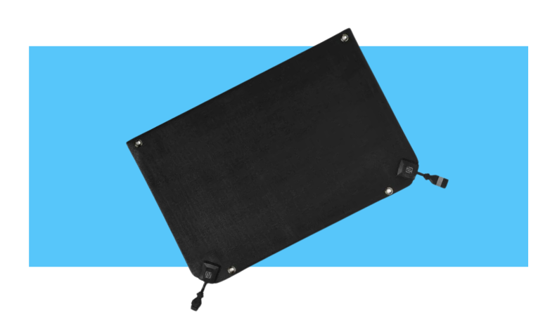 Bottom half of black HeatTrak snow melting mat in front of blue background.