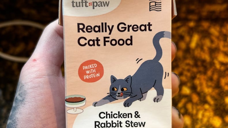 Person holding an box of Really Great Cat Food