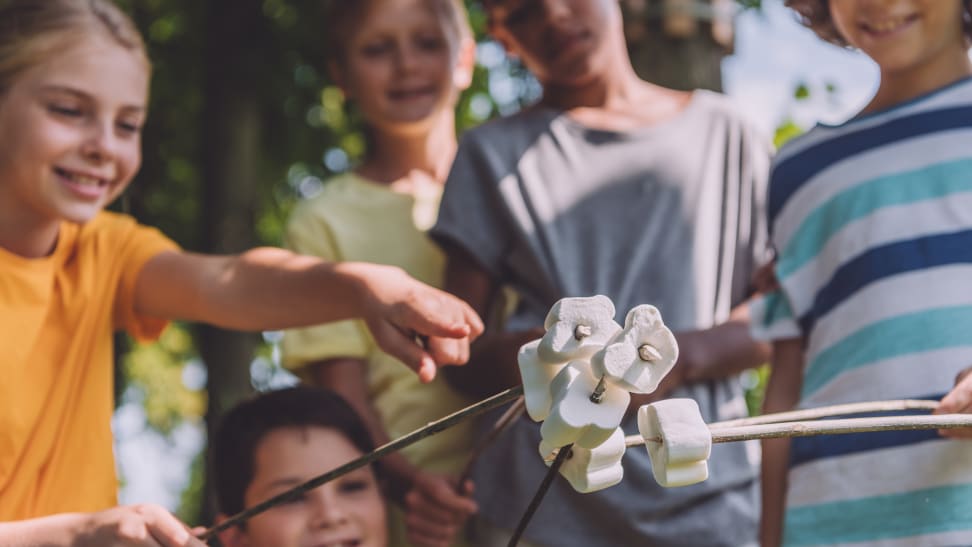 Kids roasting marshmallows at summer camp