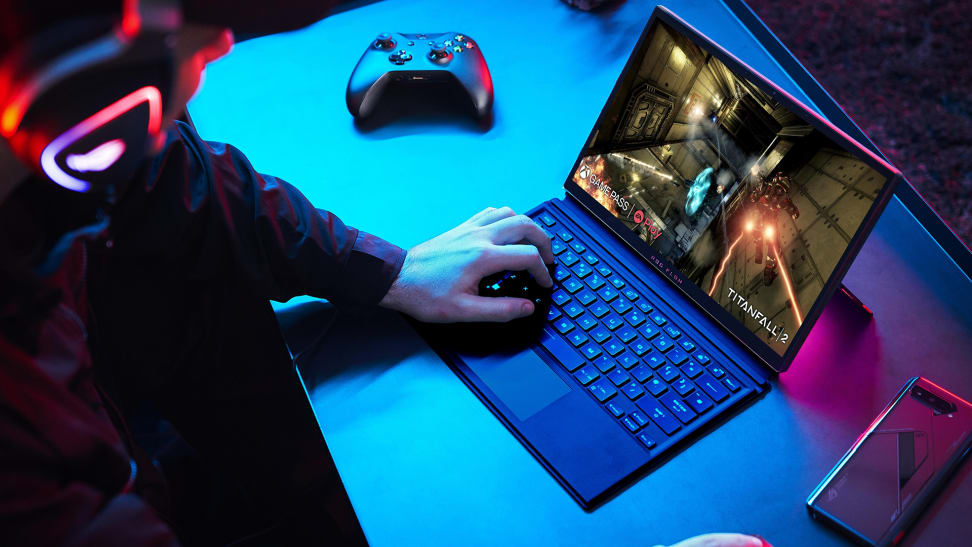 A person plays a PC game on a laptop