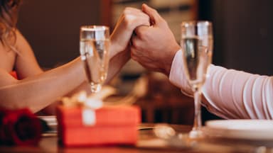 Couple holding hands with champagne