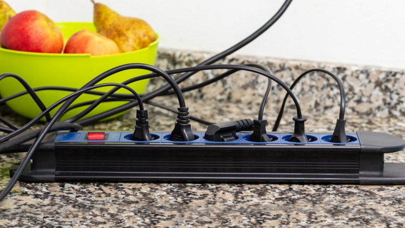 An electrical outlet with many plugs in it