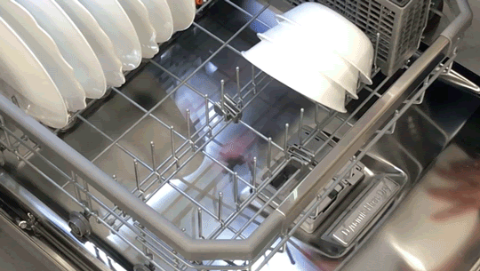 Person adjusting bottom rack on the LG-LDTH7972S dishwasher to place more bowls inside.