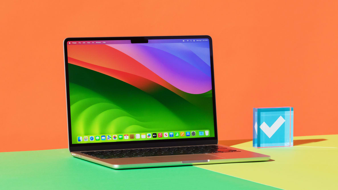 The Apple MacBook Air 13 M3 with a colorful desktop on display sitting next to the Reviewed checkmark.