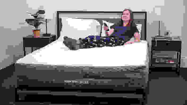 A woman laying on top of the GhostBed Luxe.
