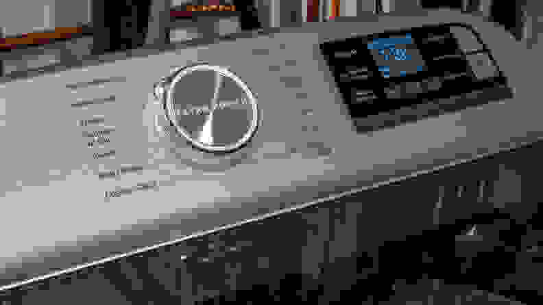 The Maytag MVW8230HC top-load washer's control panel, which consists of a large cycle selection dial and a touchpad for cycle customization options.