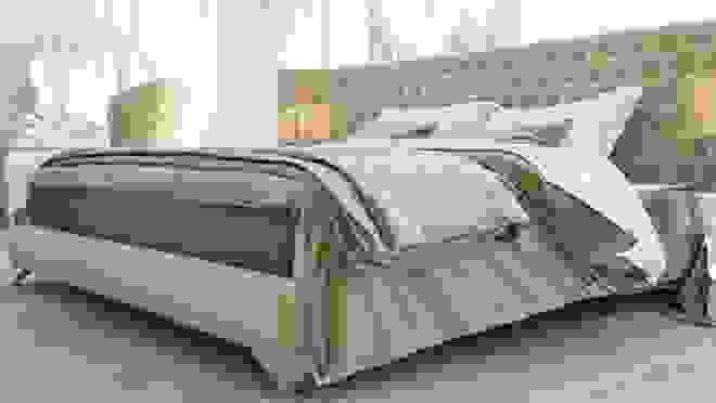 Puffy mattress in elegant bedroom with tan cushioned headboard