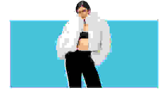 A model wearing a white faux fur jacket.