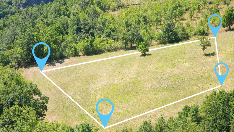 Large outdoor field with zoning lines and four points indicating where it ends.