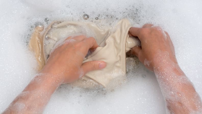 Rinsing swimsuit in soapy water