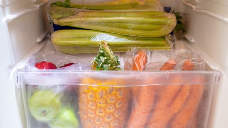 A shot of a fridge's crisper drawer filled with fresh produce.