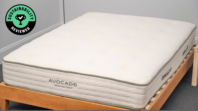 A white Avocado green mattress in a light brown wood bed frame.