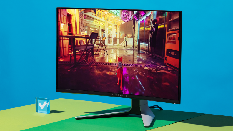 The Alienware AW3225QF, a white curved gaming monitor on a forked stand, one of the best pc gaming accessories you can buy right now