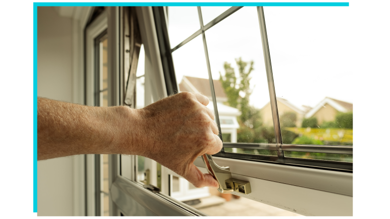 A hand opening a window.