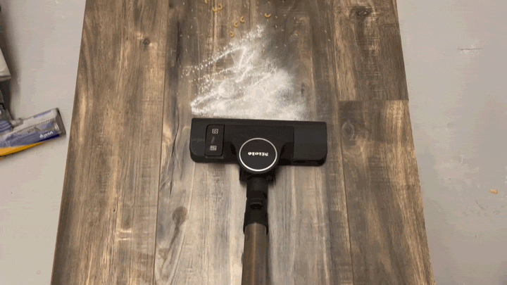 Animation of a Miele Boost CX1 vacuuming flour and pasta on a hardwood floor.
