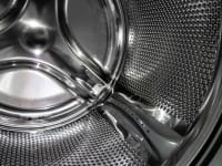 A close-up detail of a stainless steel washing machine drum
