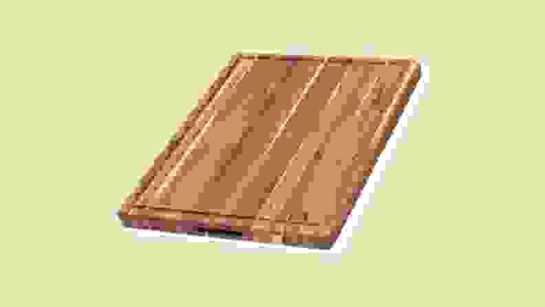 A wooden cutting board on a beige background.