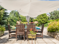 patio with table is covered by a shade sail