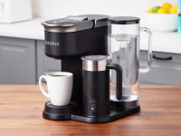 The Keurig K-Café Smart shown on a kitchen counter with a white coffee mug filled with fresh brewed coffee.