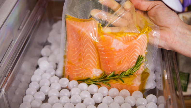 Ping pong ball sous vide bath with salmon in bag.