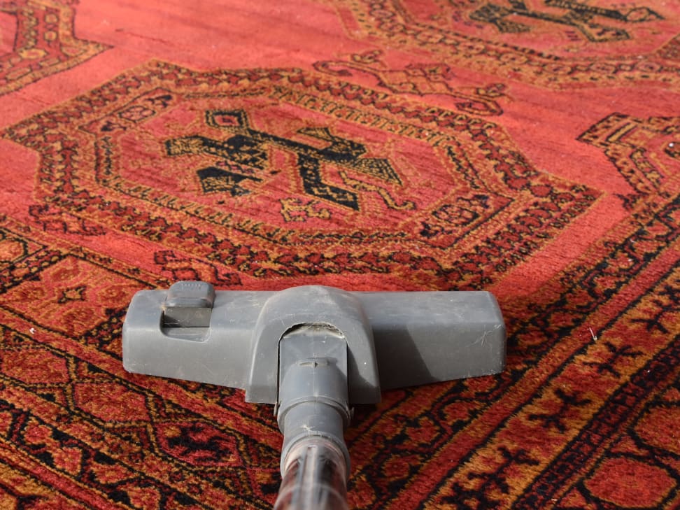 Woman Hand Cleaning Stain On Carpet With hard brush. Orange carpet