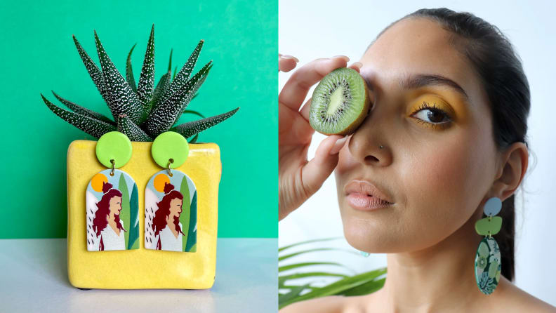 A pair of earrings on a plant next to a woman holding fruit next to her eye wearing earrings