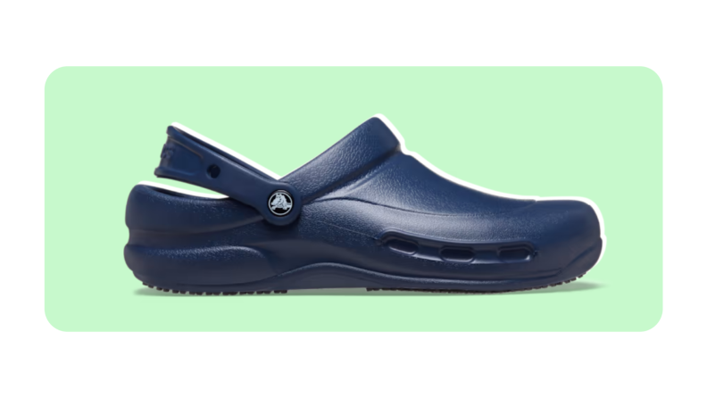 A navy blue Croc Bistro clog on a green and white background