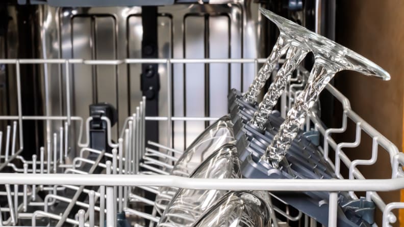 The Vinotemp Brama BR-DWSH01-S dishwasher's wine rack. A row of wine glasses are loaded, upside down, with flip-down plastic molding cradling their stems, holding them far enough apart so they won't crash into each other and break during a cycle.