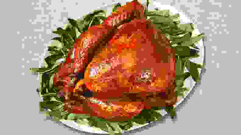 A Thanksgiving turkey on a bed of lettuce, shot from above.
