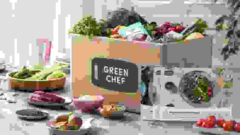 Green Chef box with ingredients and menu cards in front