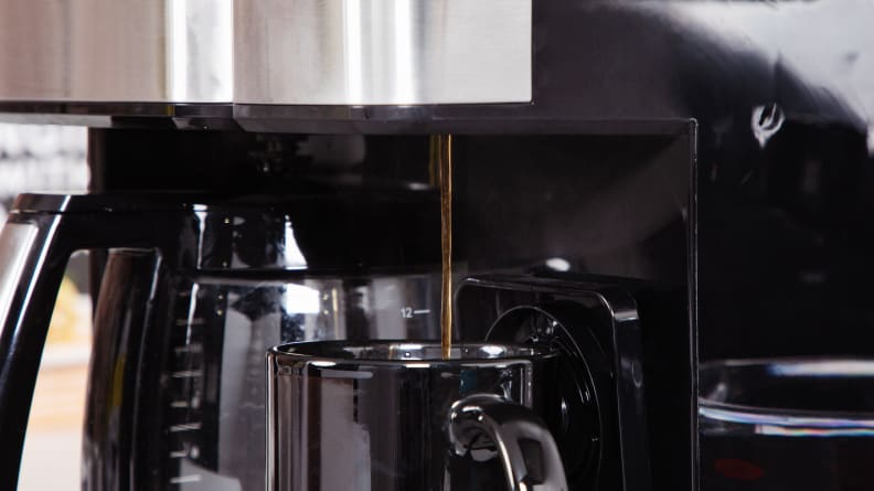 The Cuisinart Grind and Brew coffee machine making coffee and pouring fresh coffee into a cup.