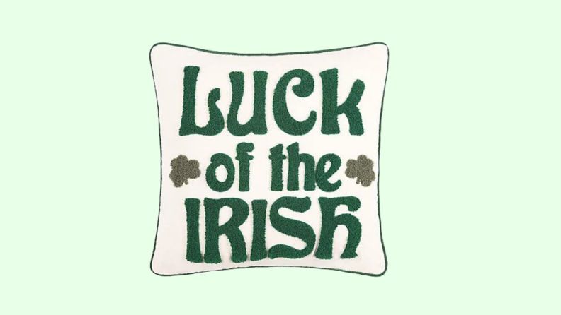 Decorative cream and white throw pillow that reads 'Luck of the Irish.'
