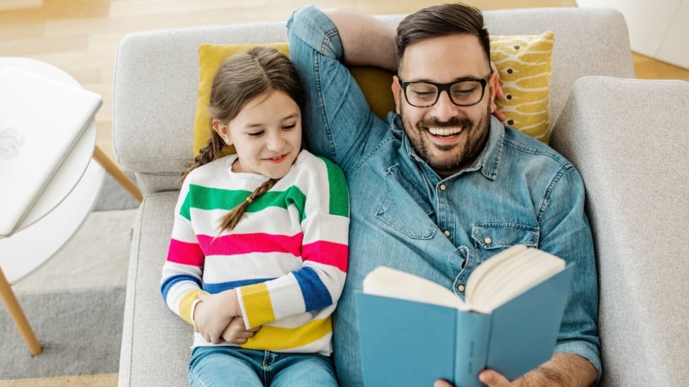 Father reading a book to daughter