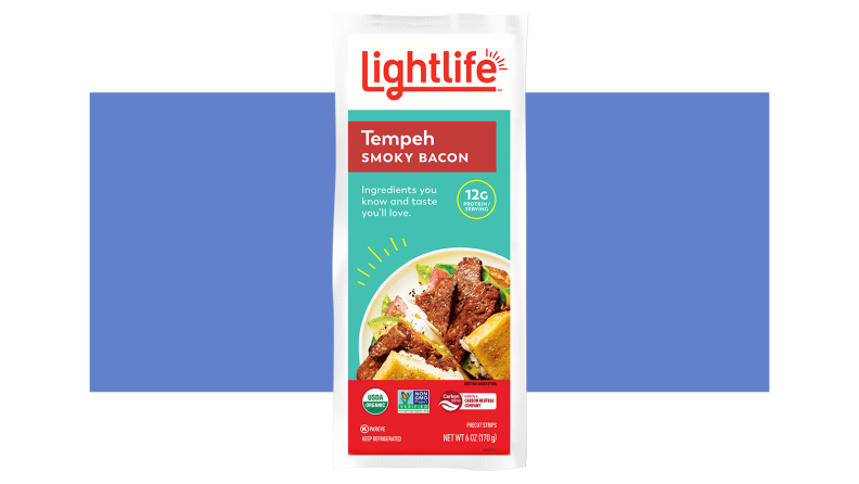 A white rectangle box with a teal Lightlife Tempeh Smoky Bacon label.
