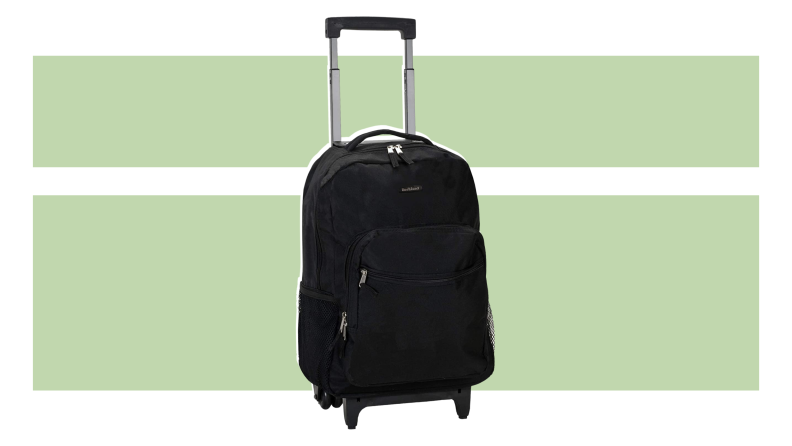 The Rockland Double Handle Rolling backpack on a green background.