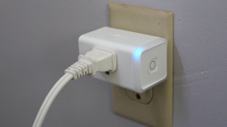 The Kasa Matter Smart Plug with Energy Monitoring plugged into an electrical socket