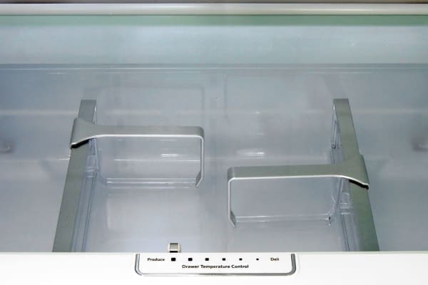 A glass shelf at the bottom of the KitchenAid KFXS25RYMS's fridge zone lets you look down into the central drawer. That drawer's temperature slider—seen here at the bottom—lets you turn it into a big crisper or deli bin.
