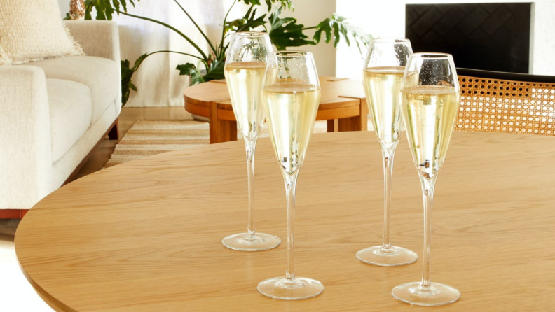 A set of tapered champagne flutes on a table.