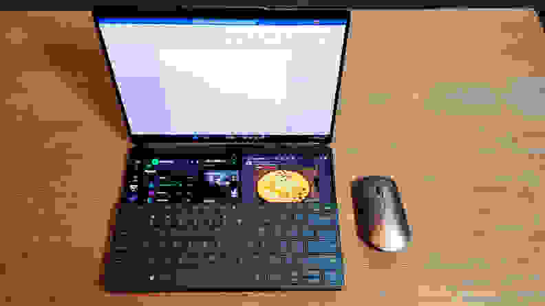 A dual-screen laptop with a keyboard attached to the lower half of the bottom display.