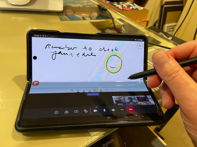 Person using stylus pen to write on screen of smartphone.