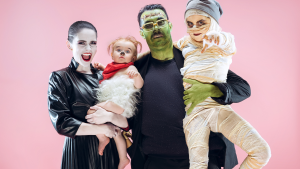 A family of ghoulish characters: A vampire mom, a Frankenstein dad, a mummy child, a werewolf baby.