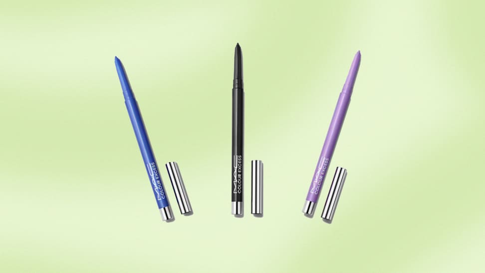 Three multicolored eyeliner pencils against a green background.