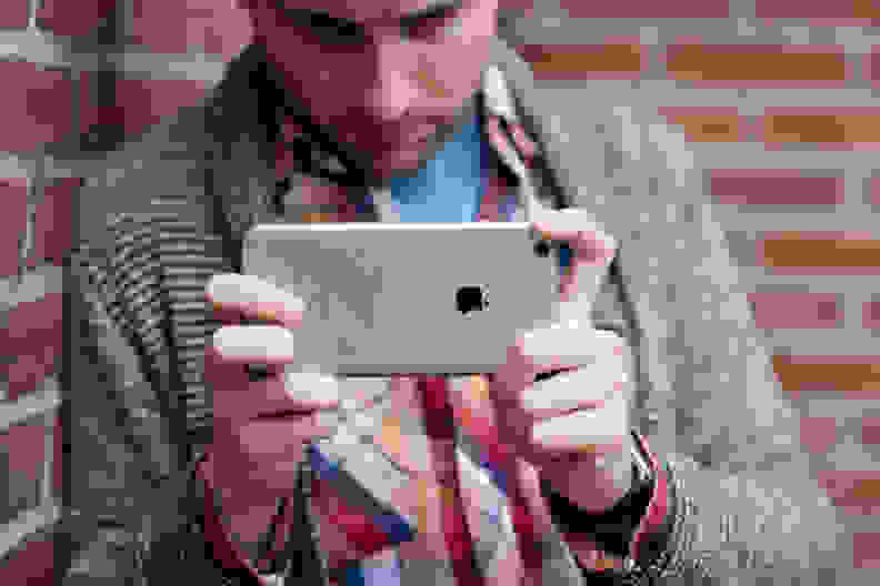 A person framing a shot using the iPhone 6s Plus's camera