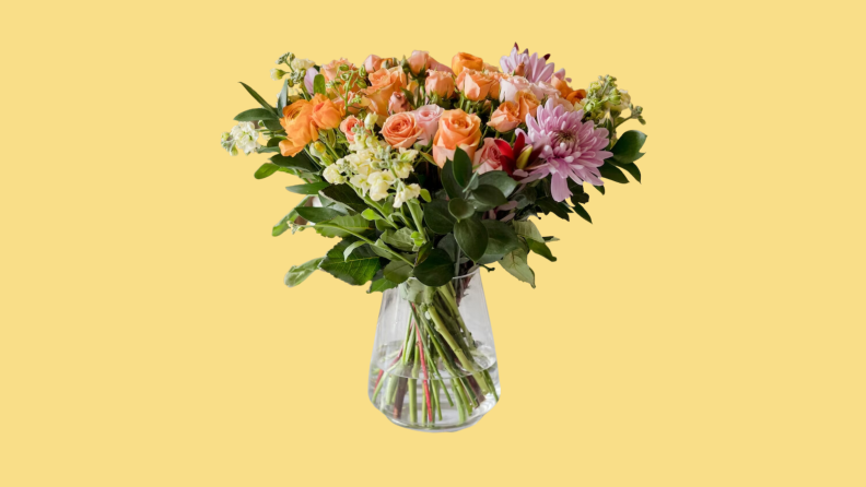 A bouquet of BloomsyBox flowers in a vase on a yellow background.