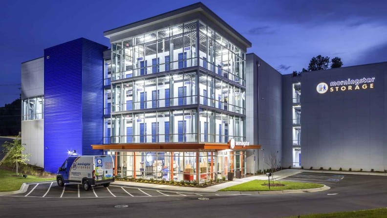 A large storage facility with a moving truck parked outside