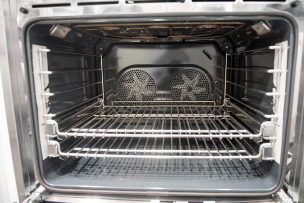 Oven cavity with convection fans and oven racks